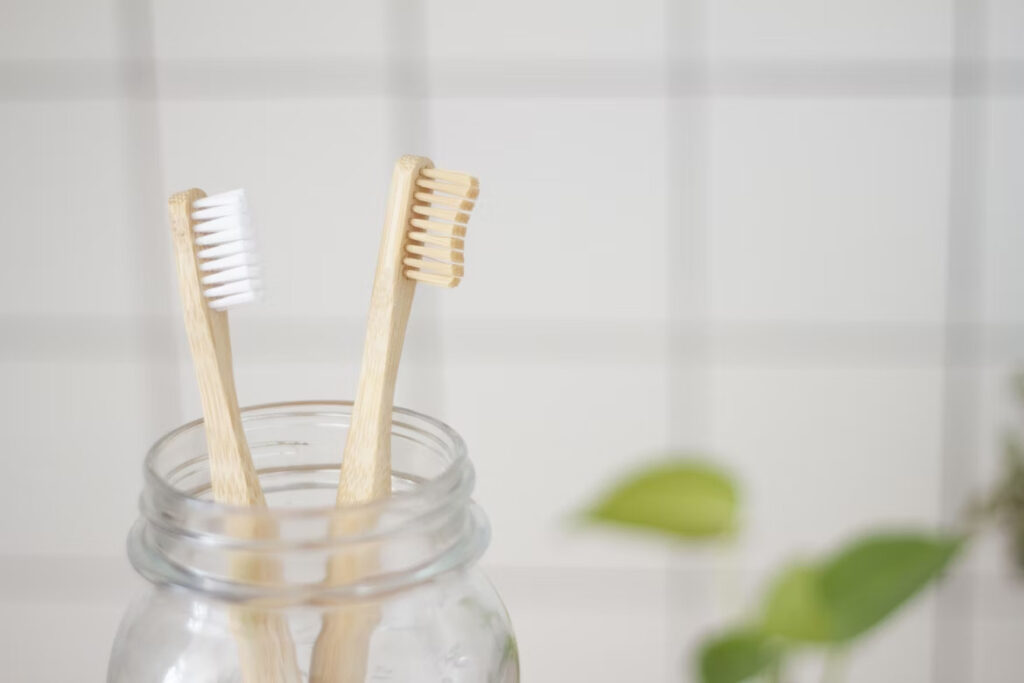 two wooden toothbrush inside a clear jar