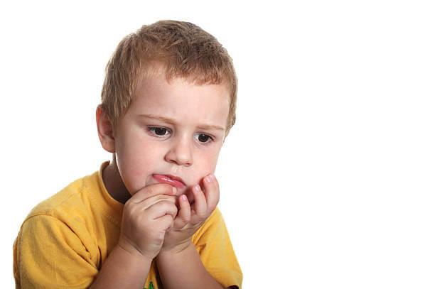 a young child with his hands cupping his chin