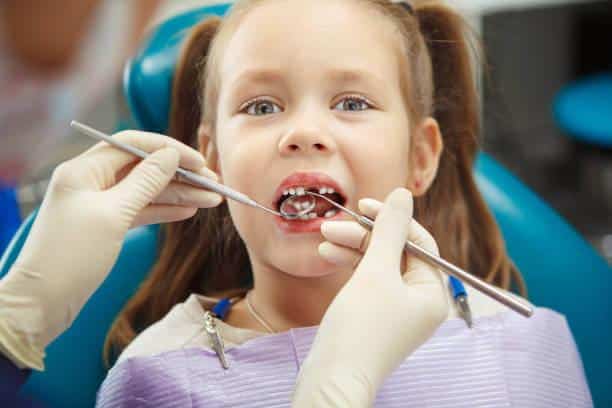 a child getting her teeth checked
