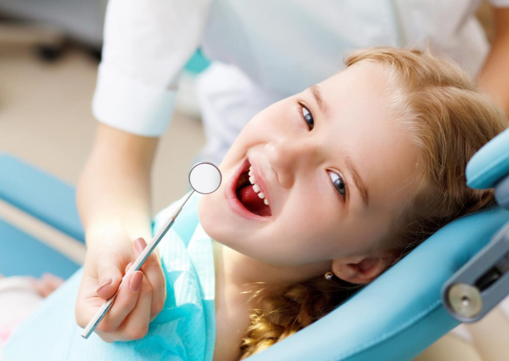 Young child receiving a dental exam before placement of a pediatric dental spacer to preserve space for permanent teeth.