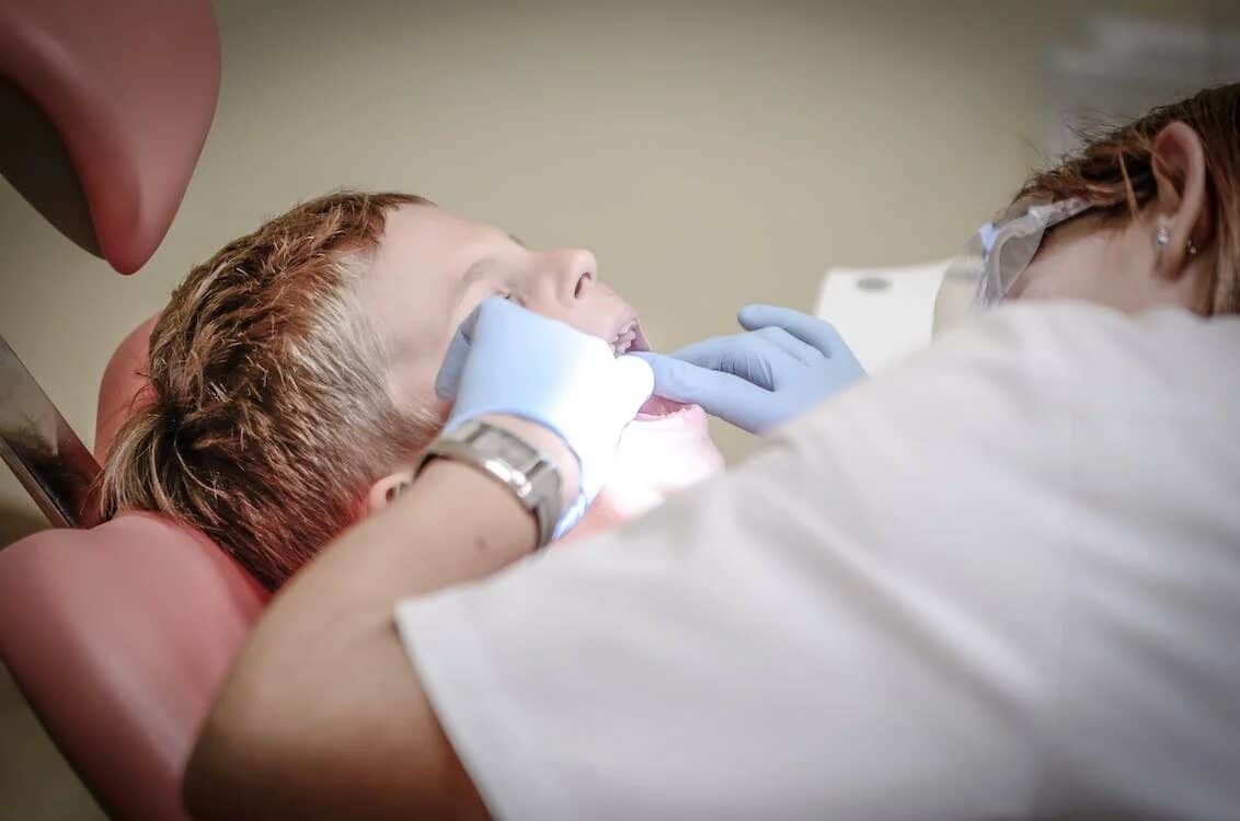 a little kid during a dental procedure
